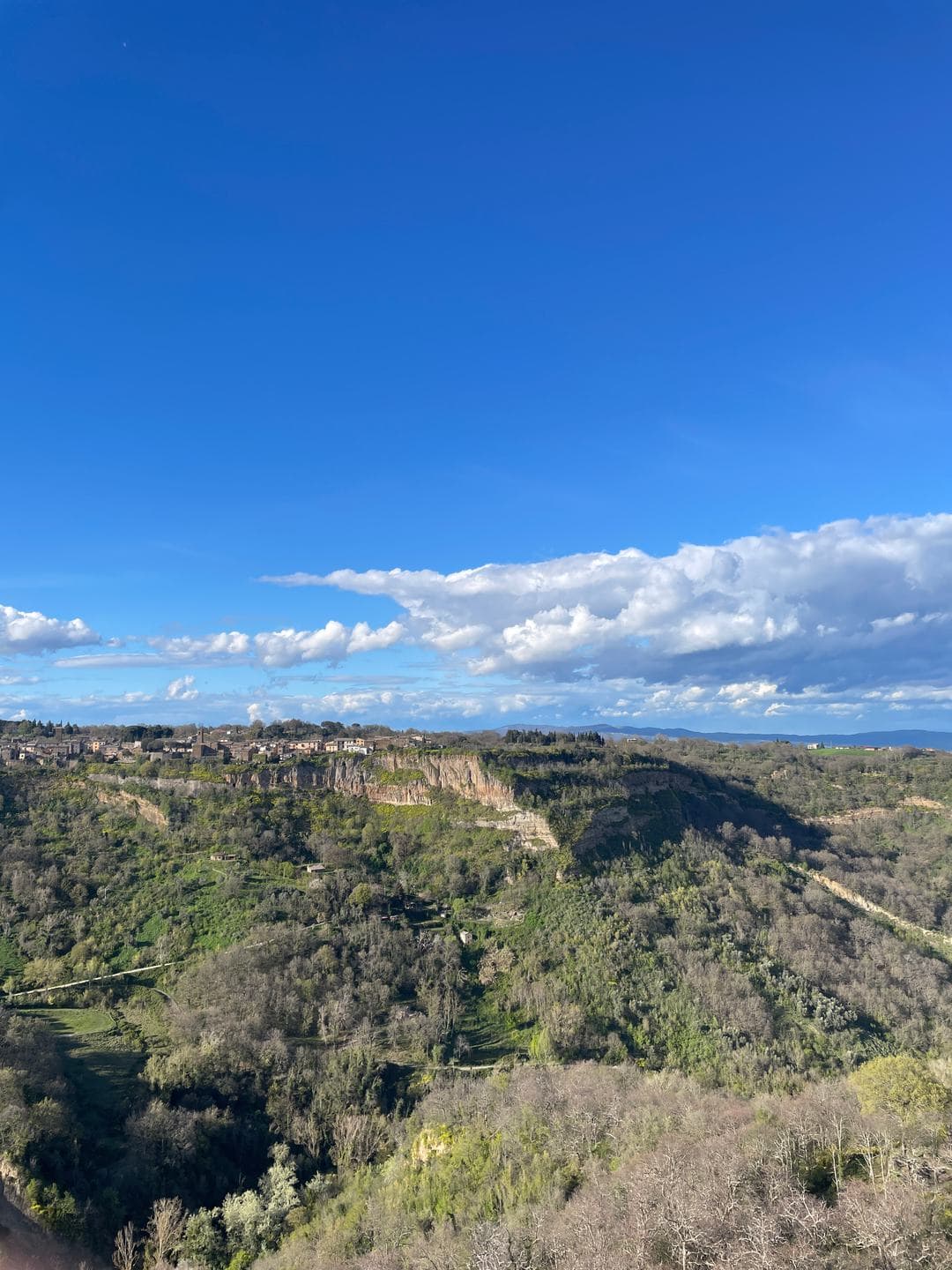 The valley of calanchi under a deep blue sky