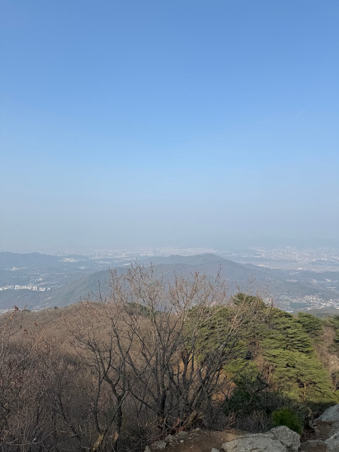 A hazy view over the ridges toward the city