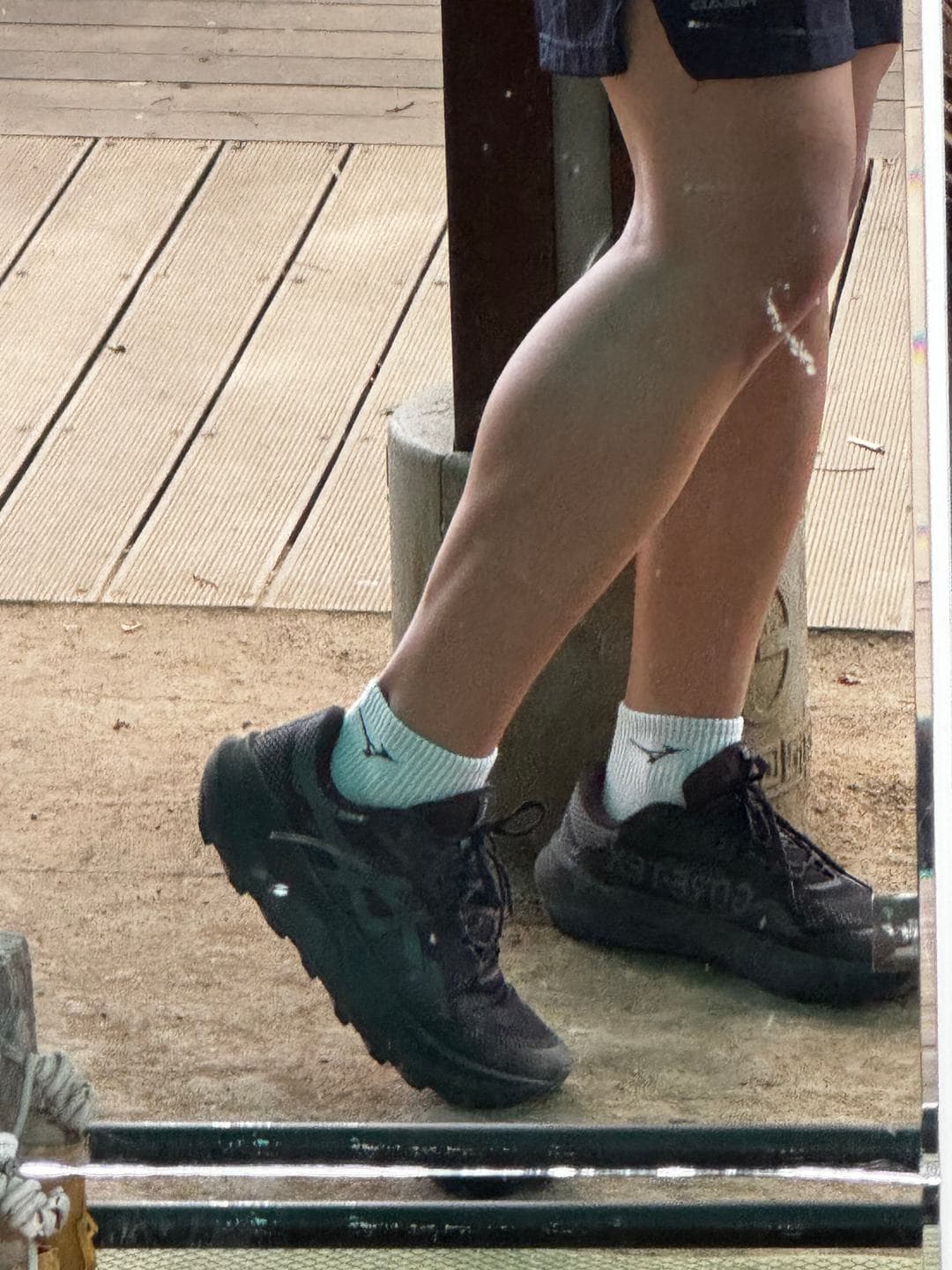 Running shoes and legs on the summit deck