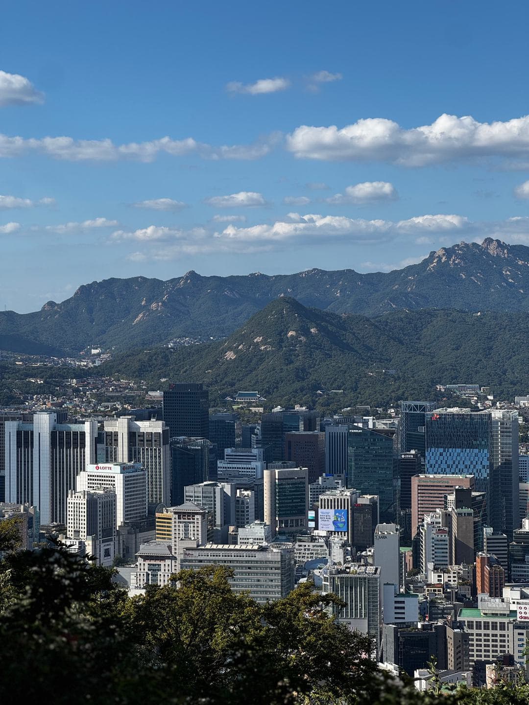 Downtown towers below and granite peaks on the northern horizon
