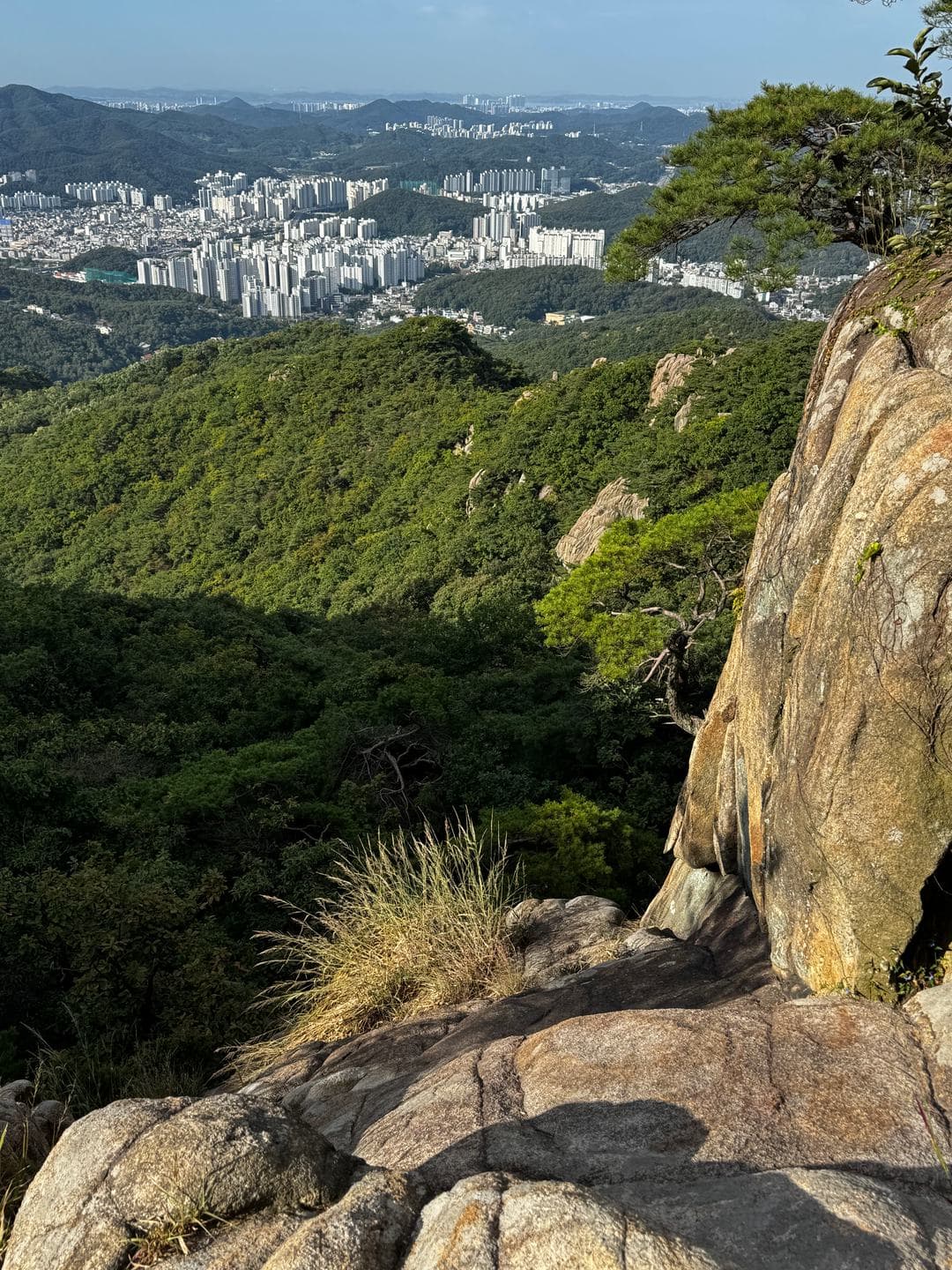 Granite outcrops with the city spread below