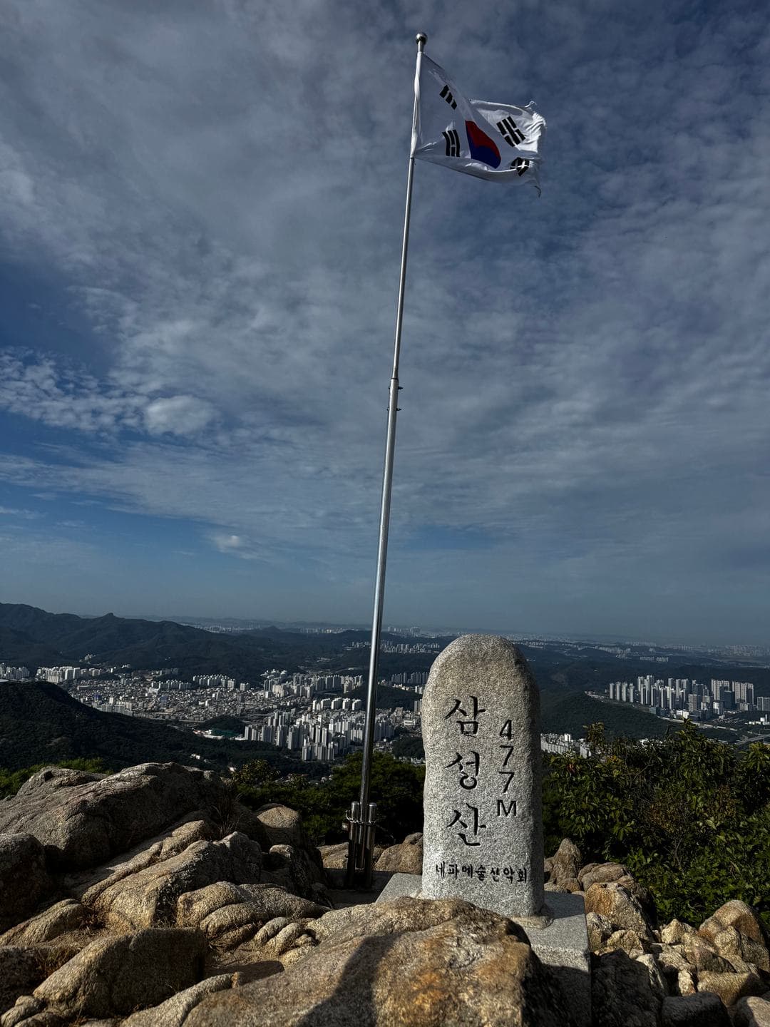 The Samseongsan summit stone, 477 m, beside a flagpole