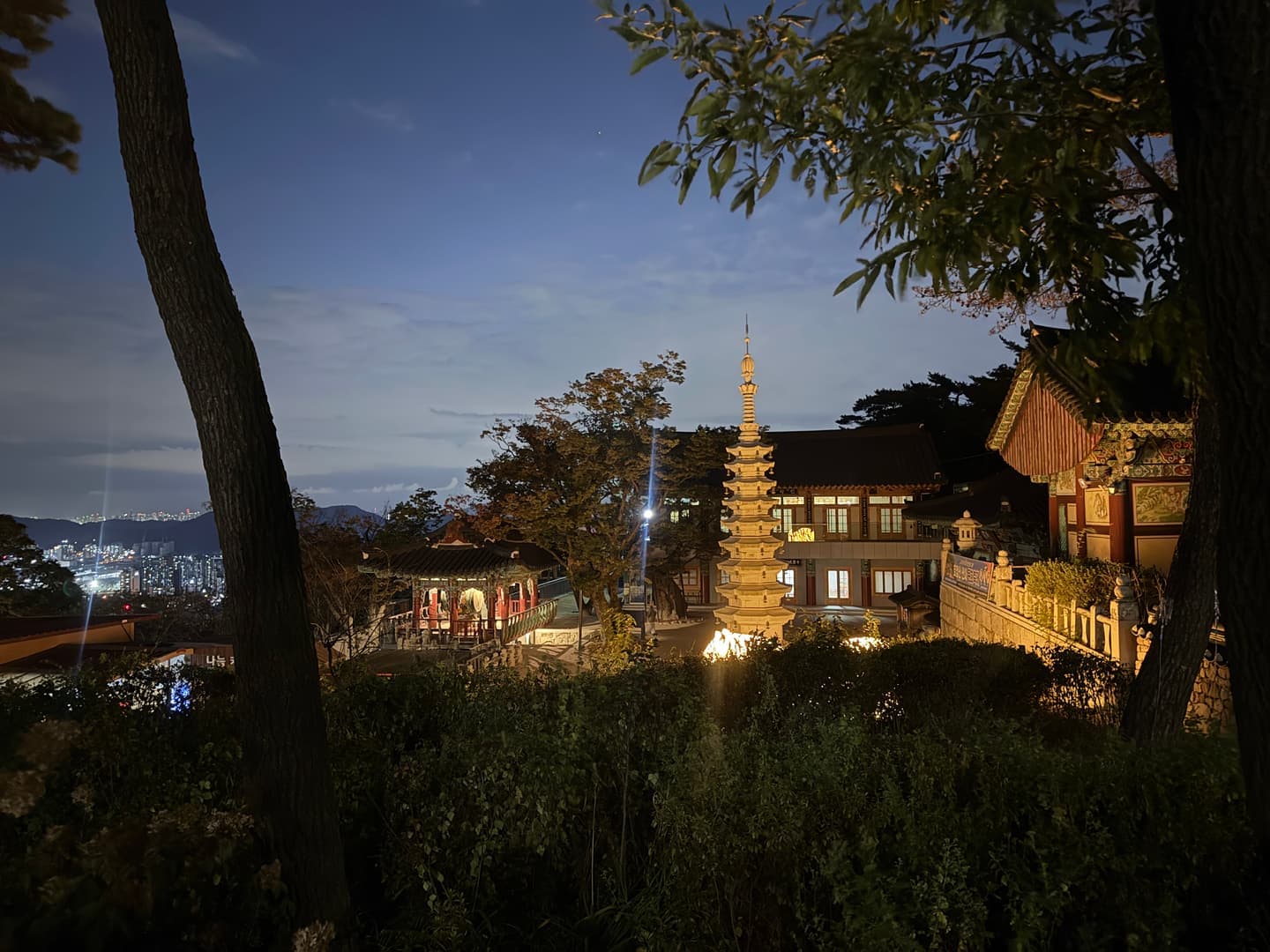 Hoapsa temple with its stone pagoda lit up at dusk