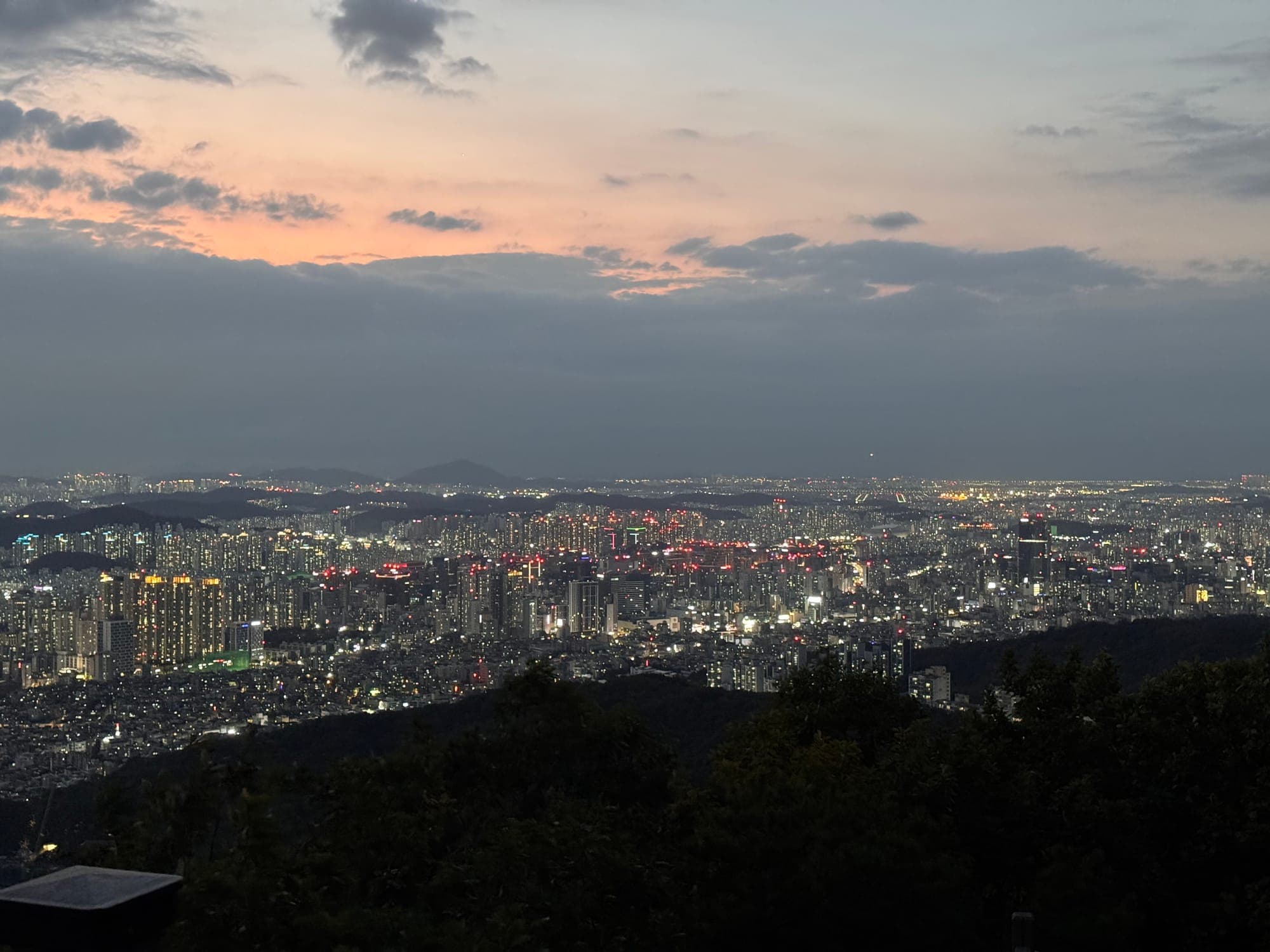 Sunset over the southwest of Seoul from Hoamsan, the city lights just coming on