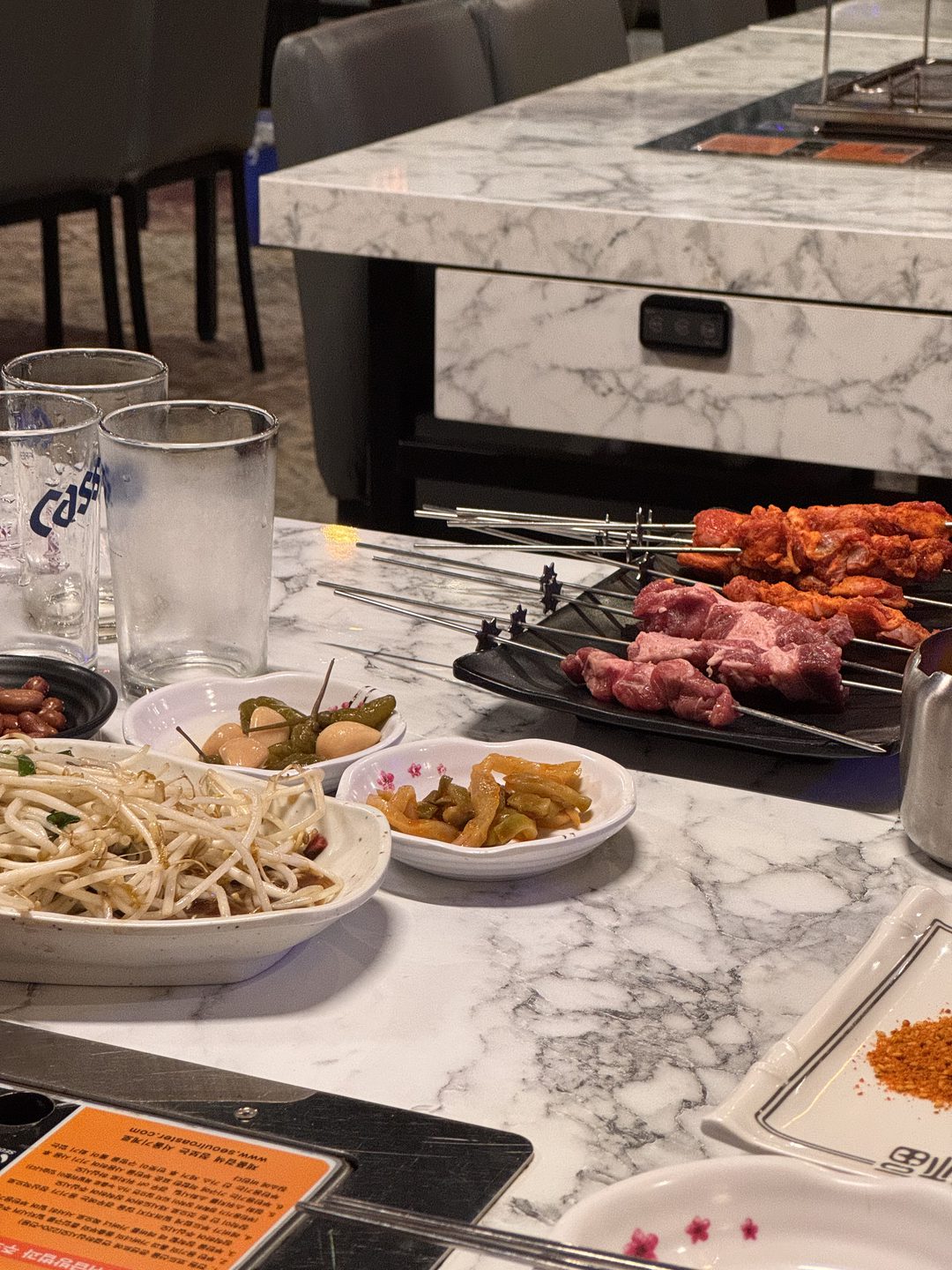접시에 담겨 나온 양꼬치와 빨간 양념 꼬치들, 옆에 숙주와 반찬