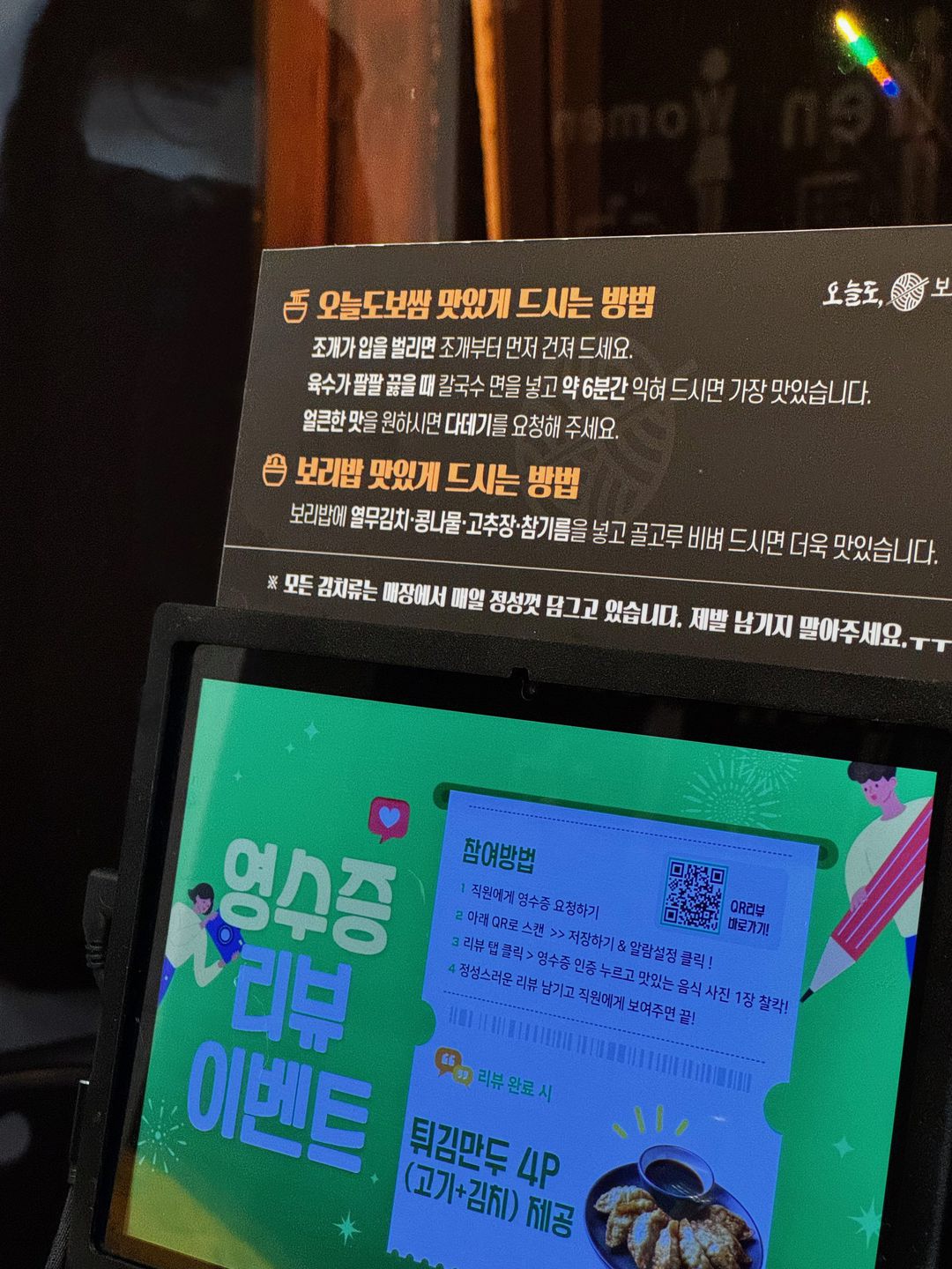 Cartel de mesa que explica cómo disfrutar mejor el bossam de Oneuldo y el arroz de cebada